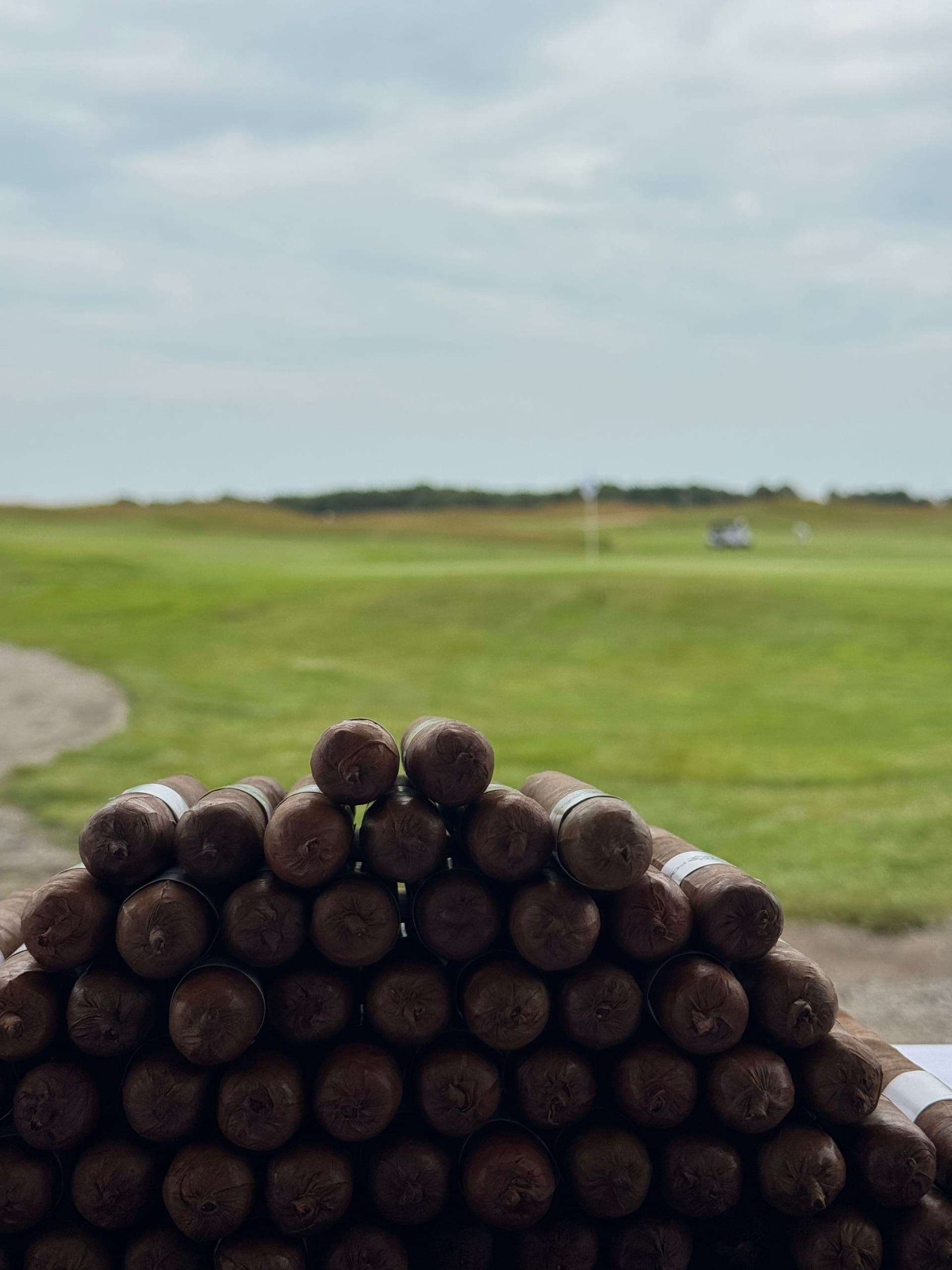 A cigar roller at work on a rolling board at an outdoor event